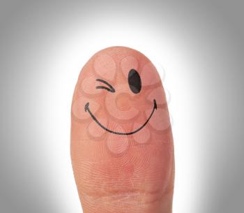 Female thumbs with smile face on the finger, eye blinking