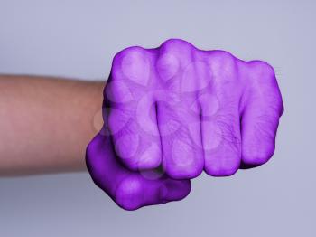 Very hairy knuckles from the fist of a man punching, purple skin