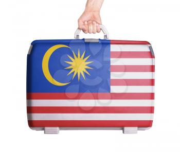 Used plastic suitcase with stains and scratches, printed with flag, Malaysia