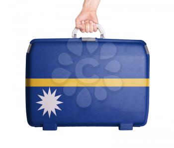 Used plastic suitcase with stains and scratches, printed with flag, Nauru