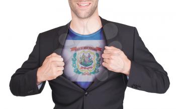 Businessman opening suit to reveal shirt with state flag (USA), West Virginia