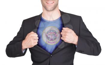 Businessman opening suit to reveal shirt with state flag (USA), Minnesota