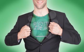 Businessman opening suit to reveal shirt with flag, Saudi Arabia