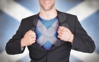 Businessman opening suit to reveal shirt with flag, Scotland