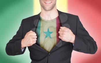 Businessman opening suit to reveal shirt with flag, Senegal