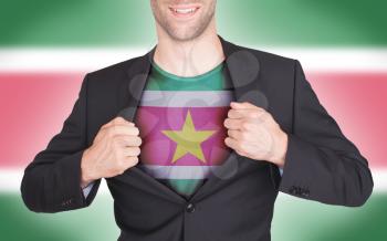 Businessman opening suit to reveal shirt with flag, Suriname