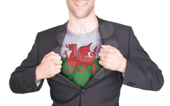 Businessman opening suit to reveal shirt with flag, Wales