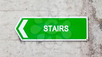 Green sign on a concrete wall - Stairs