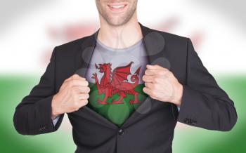 Businessman opening suit to reveal shirt with flag, Wales