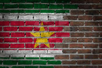 Very old dark red brick wall texture with flag - Suriname