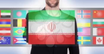 Hand pushing on a touch screen interface, choosing language or country, Iran