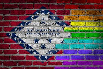 Dark brick wall texture - coutry flag and rainbow flag painted on wall - Arkansas