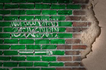 Dark brick wall texture with plaster - flag painted on wall - Saudi Arabia
