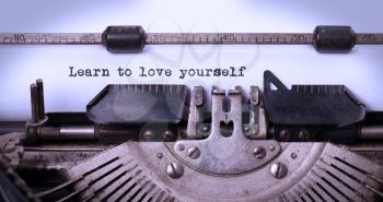 Vintage inscription made by old typewriter, learn to love yourself