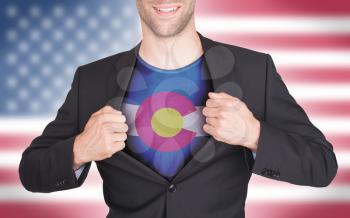Businessman opening suit to reveal shirt with state flag (USA), Colorado