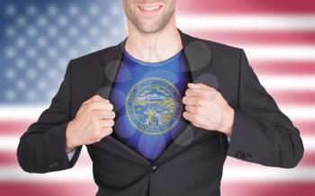 Businessman opening suit to reveal shirt with state flag (USA), Nebraska