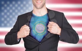 Businessman opening suit to reveal shirt with state flag (USA), South Dakota