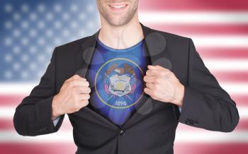 Businessman opening suit to reveal shirt with state flag (USA), Utah