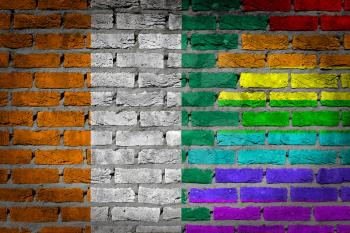 Dark brick wall texture - coutry flag and rainbow flag painted on wall - Ivory Coast