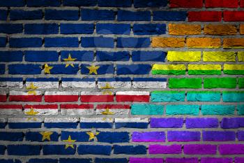 Dark brick wall texture - coutry flag and rainbow flag painted on wall - Cape Verde