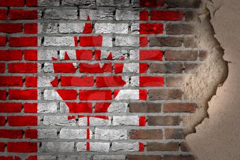 Dark brick wall texture with plaster - flag painted on wall - Canada