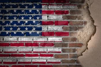 Dark brick wall texture with plaster - flag painted on wall - USA