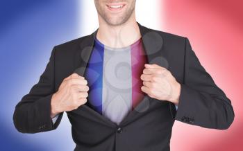 Businessman opening suit to reveal shirt with flag, France