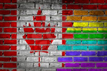 Dark brick wall texture - coutry flag and rainbow flag painted on wall - Canada