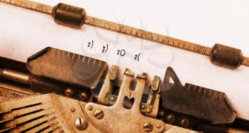 Close-up of a vintage typewriter, old and rusty, smileys