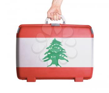 Used plastic suitcase with stains and scratches, printed with flag, Lebanon