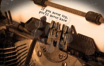 Close-up of an old typewriter with paper, selective focus, If you never try you'll never know