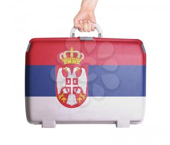 Used plastic suitcase with stains and scratches, printed with flag, Serbia