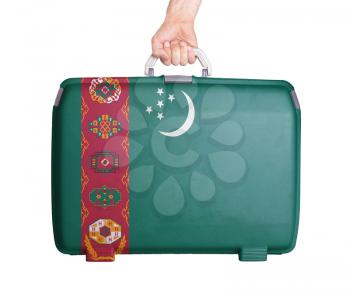 Used plastic suitcase with stains and scratches, printed with flag, Turkmenistan