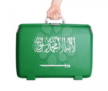 Used plastic suitcase with stains and scratches, printed with flag, Saudi Arabia