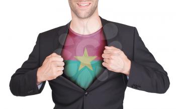 Businessman opening suit to reveal shirt with flag, Burkina Faso