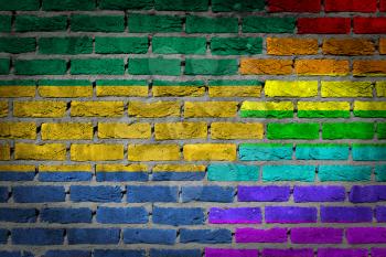 Dark brick wall texture - coutry flag and rainbow flag painted on wall - Gabon