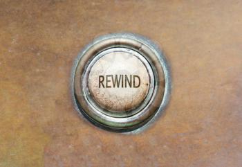 Grunge image of an old button - rewind