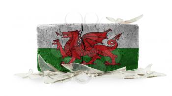 Brick with broken glass, violence concept, flag of Wales