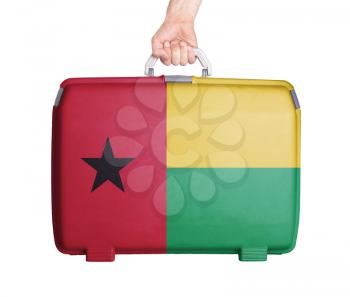 Used plastic suitcase with stains and scratches, printed with flag, Guinea Bissau