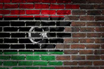 Very old dark red brick wall texture with flag - Libya