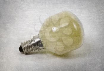 Old yellow lightbulb isolated on a white background - Vintage look
