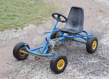 Dirty old go-kart waiting for a kid to play with it