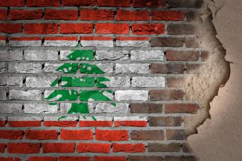 Dark brick wall texture with plaster - flag painted on wall - Lebanon
