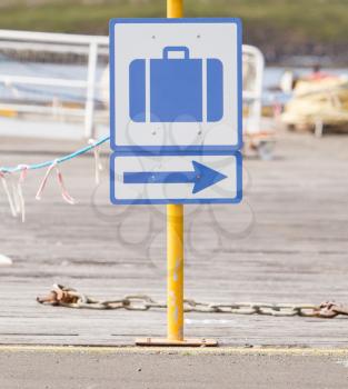 Bagage sign on a yellow pole, harbour in Iceland
