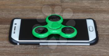 Childrens toys; Smartphone with a green spinner on top