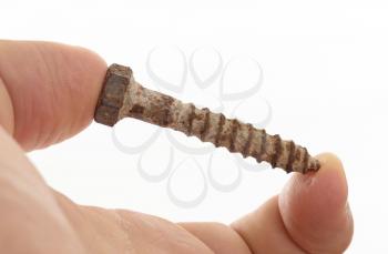 Rusted old screw isolated on white background