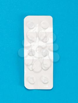 Pill strip isolated on a blue background