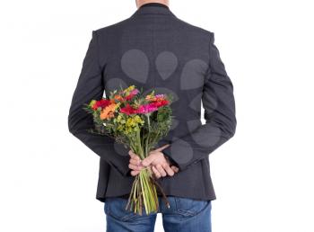 Man is hiding flowers behind his back - Isolated