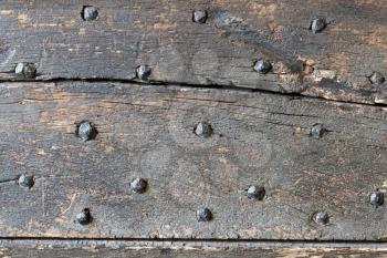 Old wood with metal nails, part of an old door