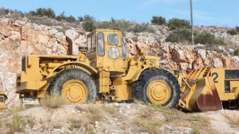 Old industrial bulldozer for stone waiting on a site in Greece